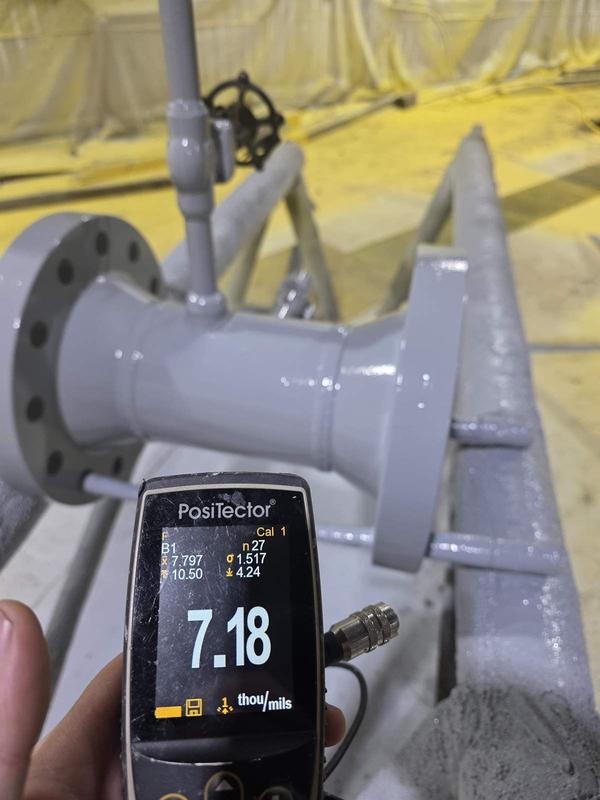 Coating thickness measurement with PosiTector gauge on industrial pipe