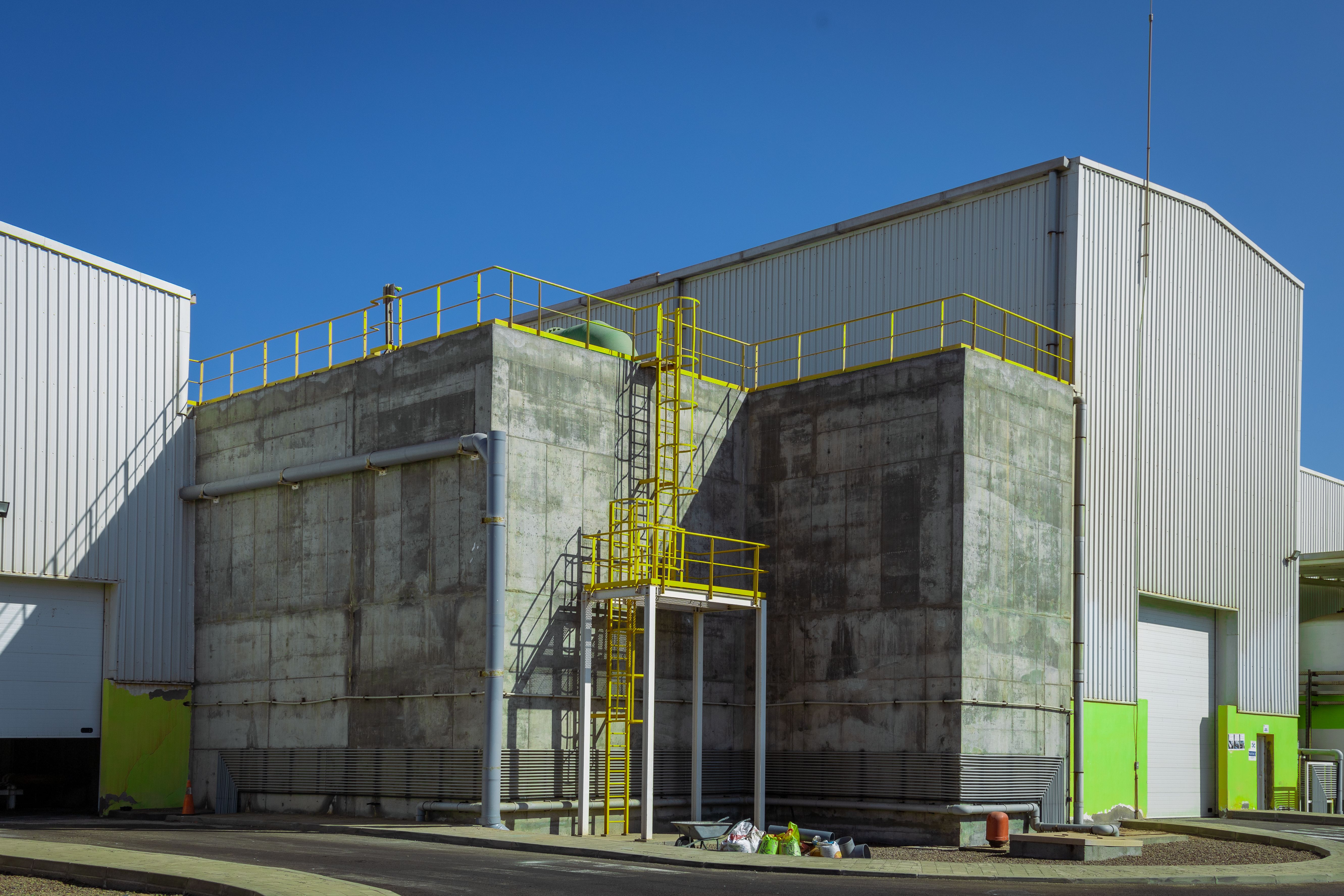 Industrial coating facility exterior with blast containment